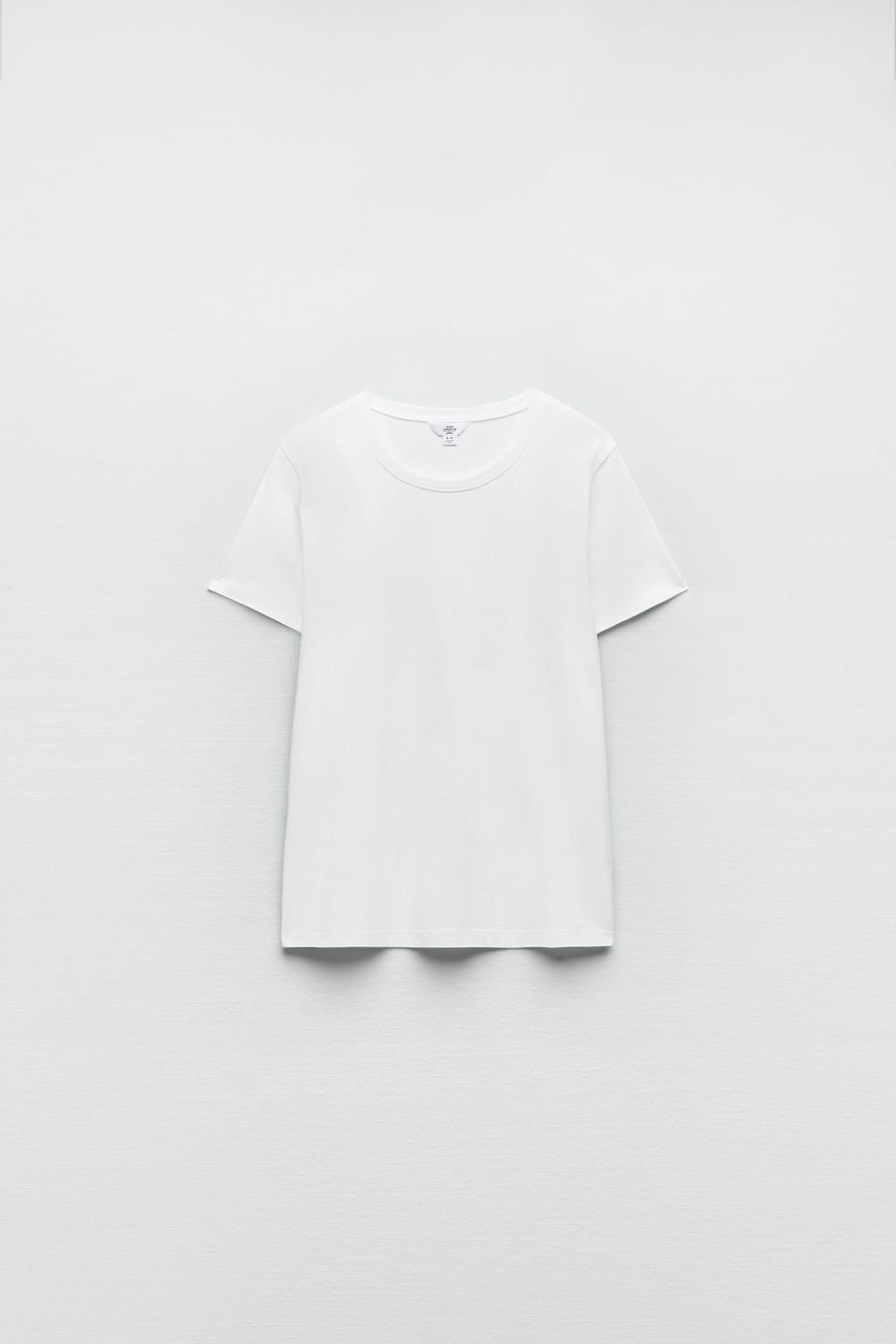 https://flyfiercefab.com/wp-content/uploads/2022/05/Good-American-X-Zara-White-Basic-T-Shirt.png